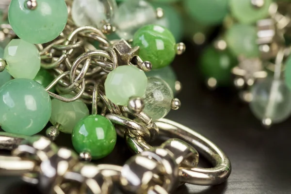 Green beads on  silver jewelry