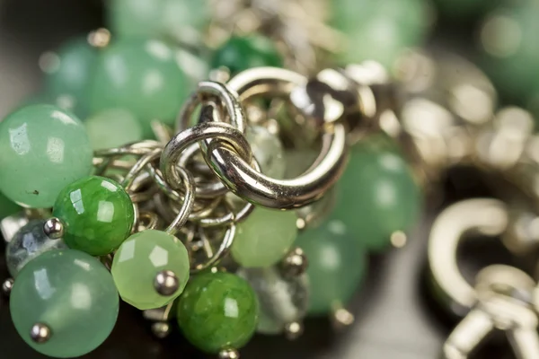 Green beads on an item of silver jewellery