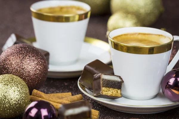 Two stylish cups of coffee with candies