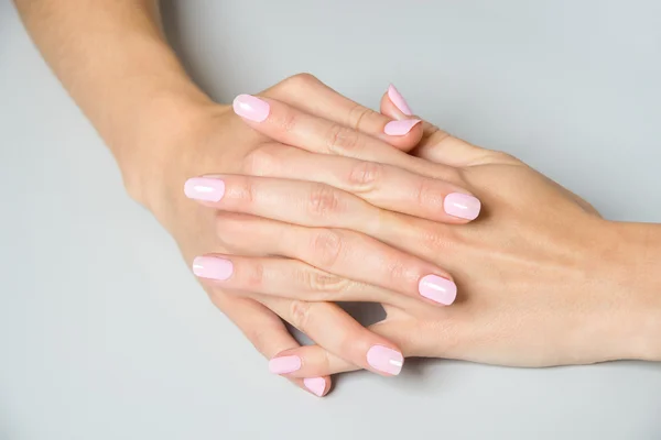 Pair of elegant hands with pink nail paint