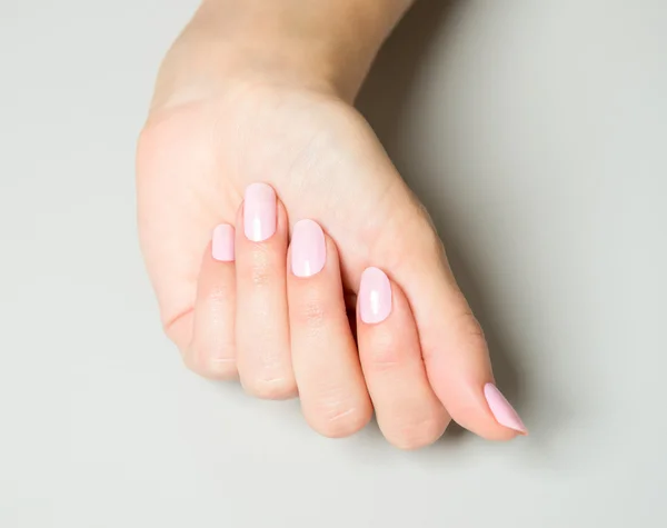 Elegant hand with pink nail paint