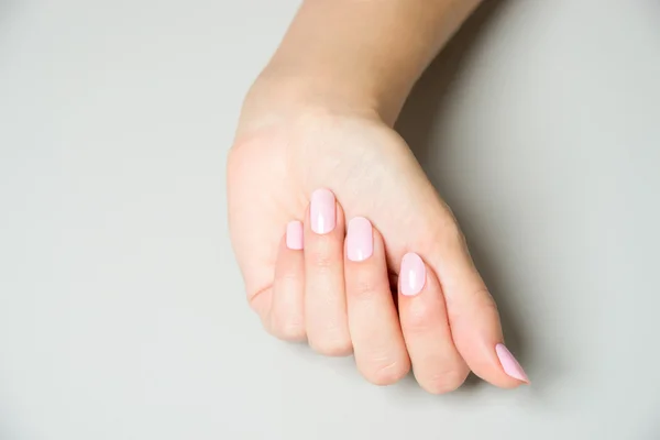 Elegant hand with pink nail paint