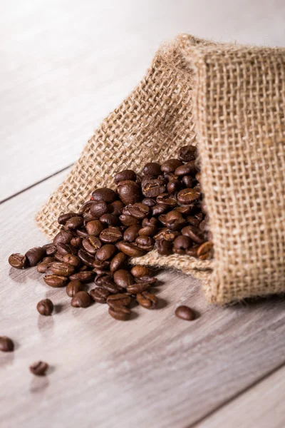 Coffee beans coming out of burlap bag