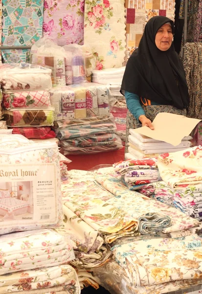 A female turkish trader selling her fabrics