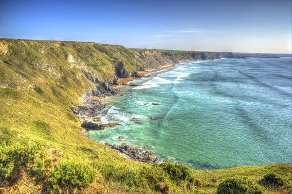 South west coast path Mawgan Porth north Cornwall England near Newquay and south of Porthcothan and Treyarnon on a summer day with blue sky towards Watergate Bay