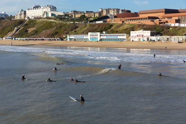 Surfers on Bournemouth beach Dorset England UK near to Poole known for beautiful sandy beaches