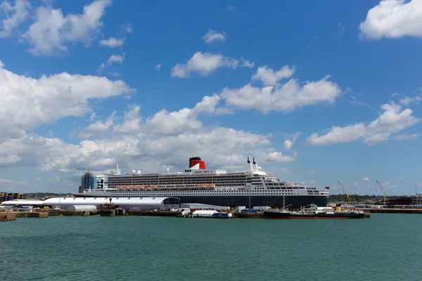 Queen Mary 2 ocean going transatlantic liner and cruise ship at Southampton Docks England UK in summer on calm day with blue sky