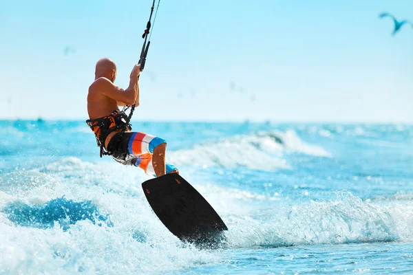 Recreational Sports. Man Kiteboarding In Sea Water. Extreme Sport