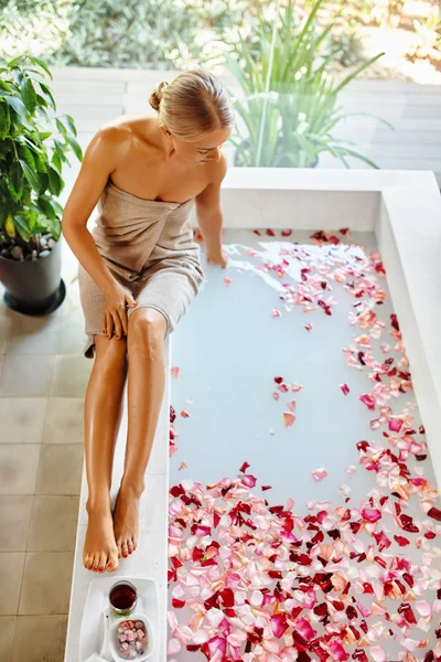 Skin Care Spa Treatment. Woman On Bathtub. Flower Rose Bath.