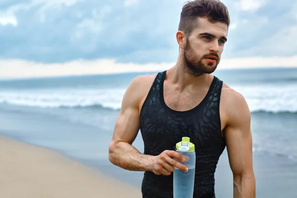 Man Drinking Refreshing Water After Workout At Beach. Drink
