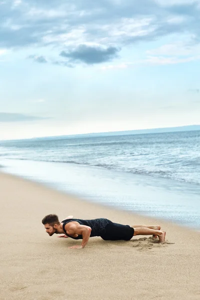 Man Doing Push Up Exercise On Beach. Body Exercising Concept