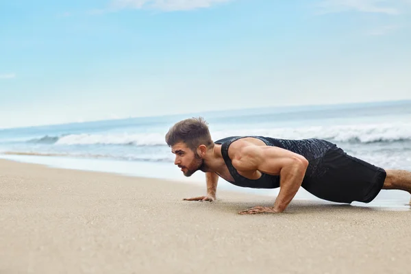 Man Exercising, Doing Push Up Exercises On Beach. Fitness Workout