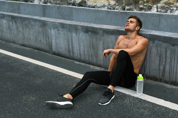 Tired Sports Man Resting After Running And Workout Exercising Outdoors