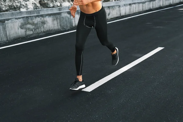 Sport. Close Up Of Male Legs Running On Road Outdoors.
