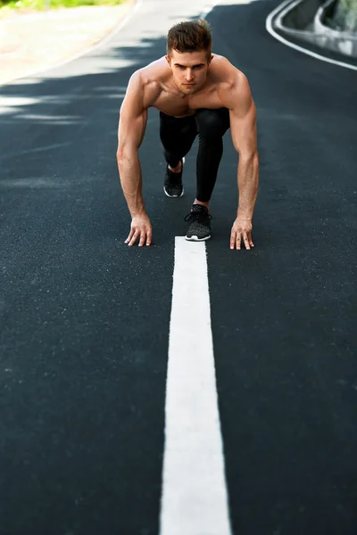 Athletic Man Ready To Start Running Outdoors. Sports Workout Concept