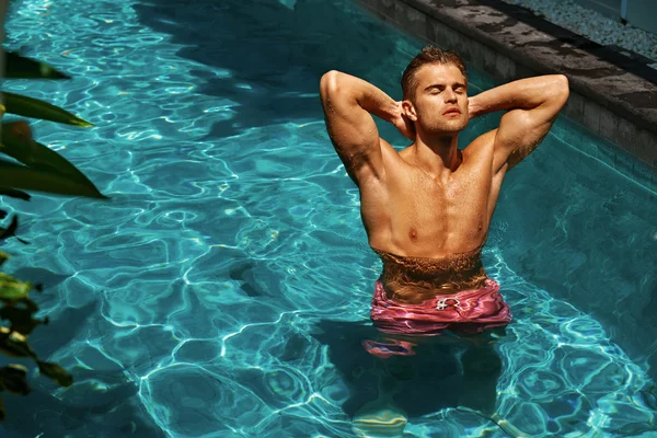 Man Relaxing In Pool Water, Sun Tanning In Summer. Pleasure