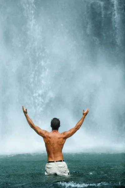 Freedom Of Life. Free Man Raising Hands Near Waterfall. Health