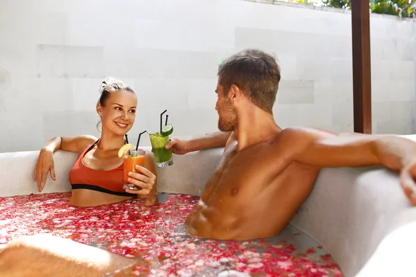 Spa Relax. Couple In Love In Flower Bath Drinking Drinks