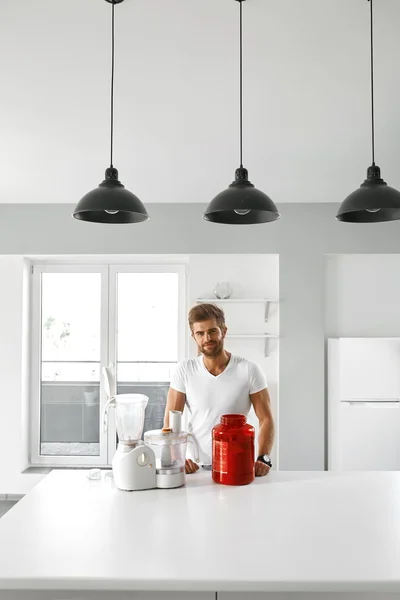 Sport Nutrition. Healthy Man Going To Prepare Shake In Kitchen