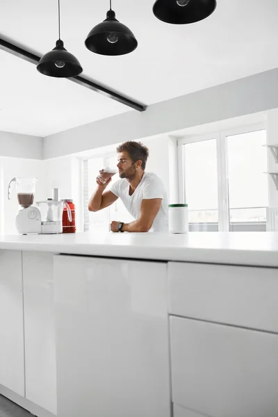 Healthy Eating. Muscular Man Drinking Sports Shake Drink Indoors