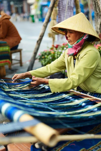 VIETNAM, HO CHI MINH - Vietnamese Woman Weaving Yarn On Street