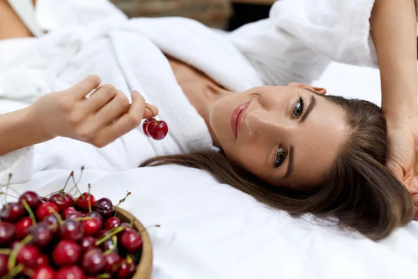 Healthy Diet Food For Woman's Health. Girl Eating Fruits On Bed