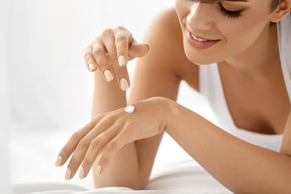 Woman Hand Cream. Close Up Of Beautiful Girl Applying Lotion