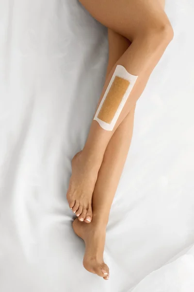 Body Care. Long Woman\'s Legs With Wax. Depilation Concept