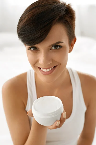 Skin Care. Beautiful Happy Woman Holding Face Cream, Lotion