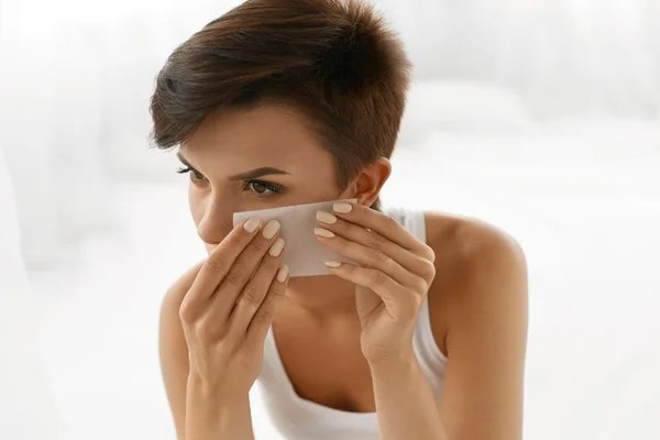 Skin Care. Woman Cleaning Face With Oil Absorbing Papers.