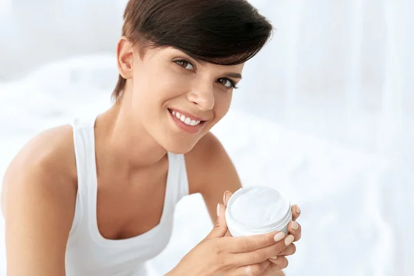 Skin Care. Beautiful Happy Woman Holding Face Cream, Lotion