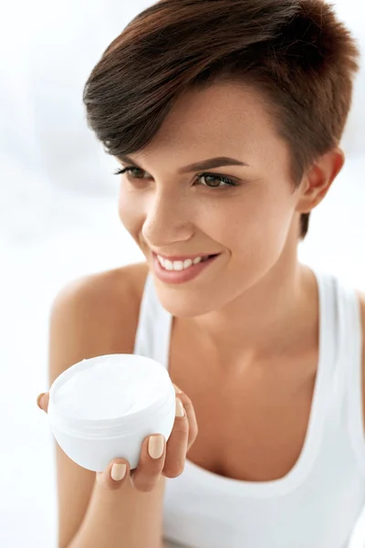 Skin Care. Beautiful Happy Woman Holding Face Cream, Lotion
