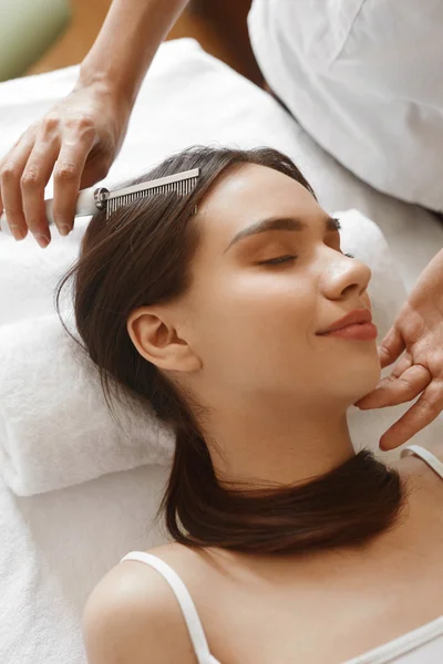 Hair Care. Beautiful Woman Receiving Brushing Beauty Treatment