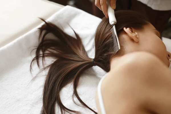 Brushing Beautiful Woman Long Hair. Hair Beauty Treatment