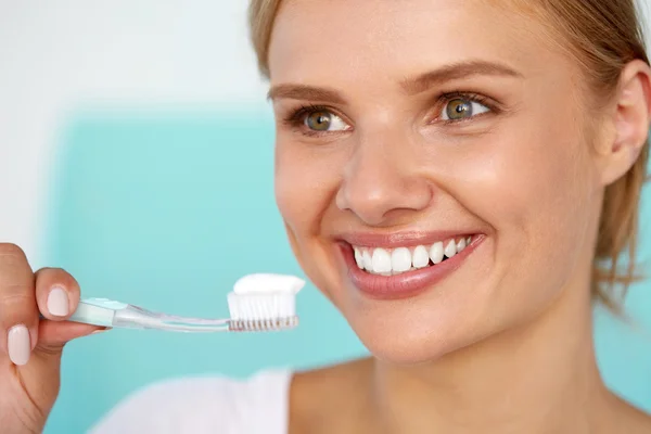 Beautiful Smiling Woman Brushing Healthy White Teeth With Brush