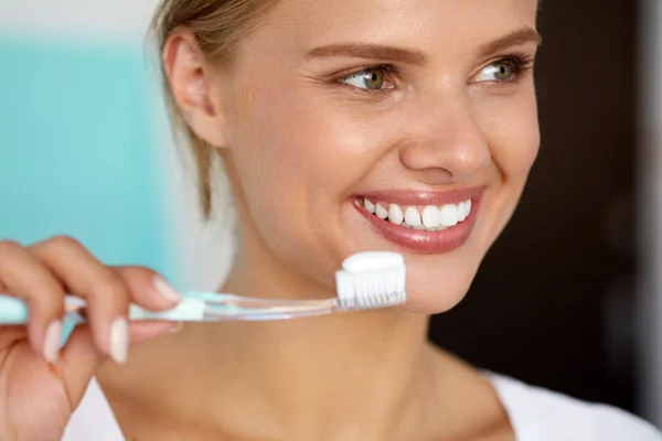 Woman With Beautiful Smile Brushing Healthy White Teeth