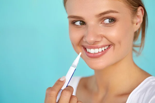 Woman With Beautiful Smile, Healthy Teeth Using Whitening Pen