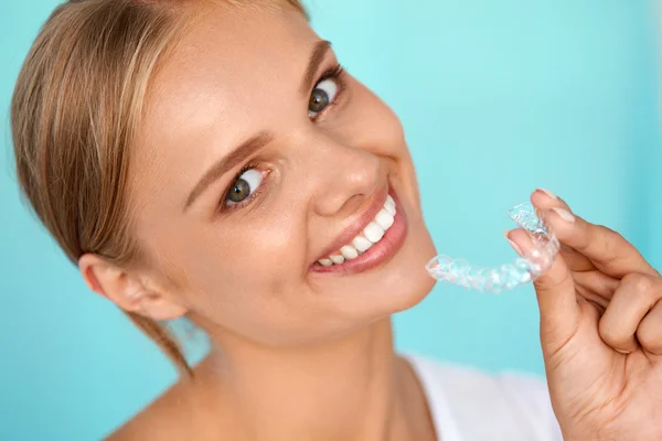 Smiling Woman With White Teeth Holding Teeth Whitening Tray