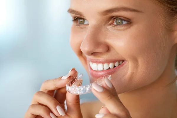 Smiling Woman With White Teeth Holding Teeth Whitening Tray