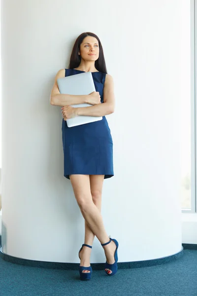 Businesswoman With Laptop Computer Standing  at The Office. Busi