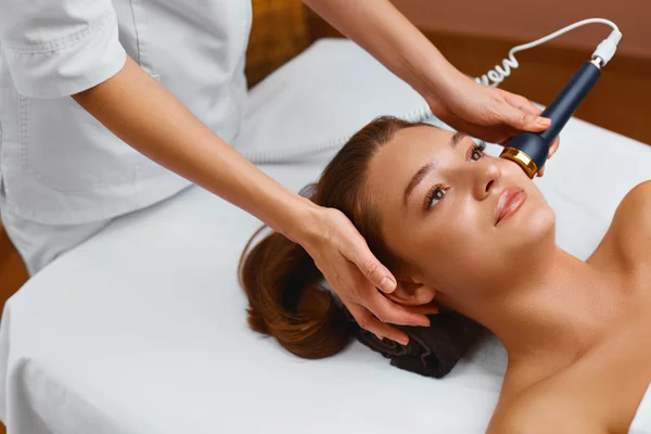Face skin care. Woman lies on a table in a beauty spa getting a