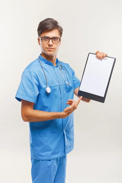 Doctor Showing Clipboard Over White Background