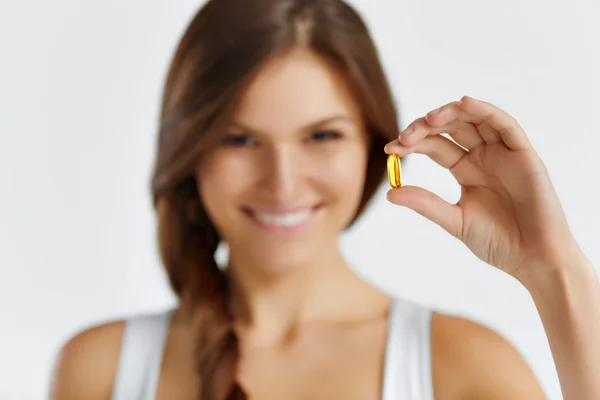 Nutrition. Healthy Lifestyle. Woman Holding Pill With Fish Oil O