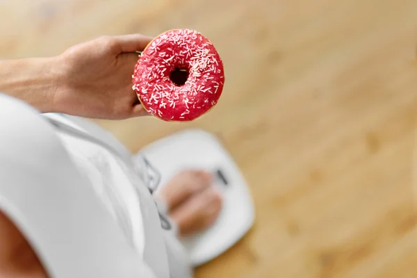 Diet Concept Woman On Scale Holding Donut Weight Loss Dieting Stock Images Page Everypixel