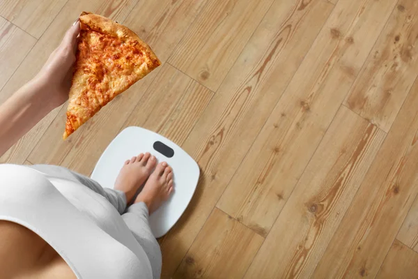 Diet, Fast Food. Woman On Scale Holding Pizza. Obesity.