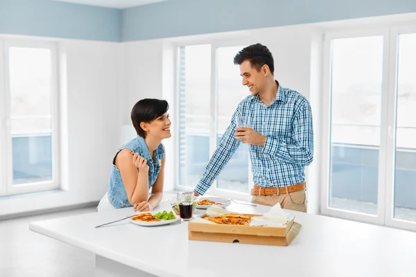Eating Food. Happy Lovely Couple Eating Pizza Indoors. Leisure C