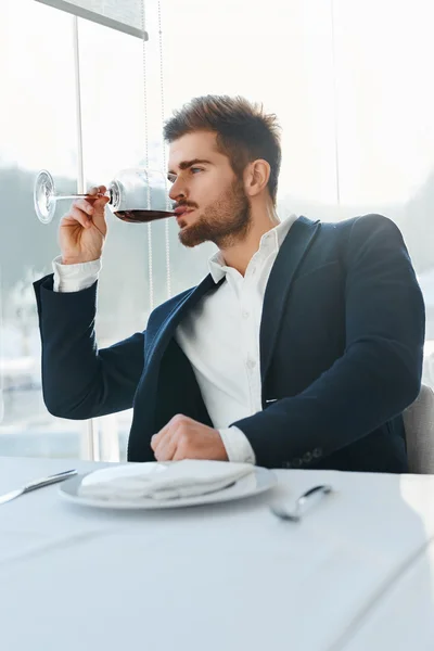 Wine. Man Tasting Wine. Businessman Drinking In Restaurant. Cele