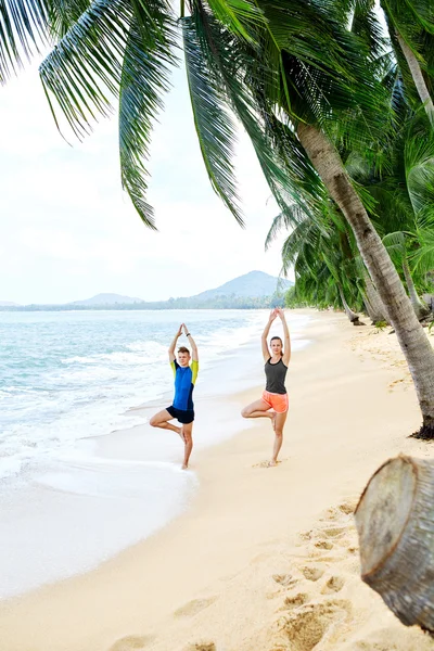 Fitness. Couple Practicing Yoga On Beach. Exercising. Sports. St