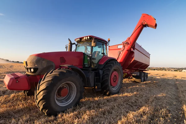 Agriculture tractor on a stubble field