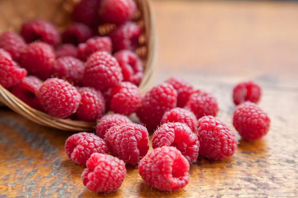 Fresh and tasty raspberries on a wooden table